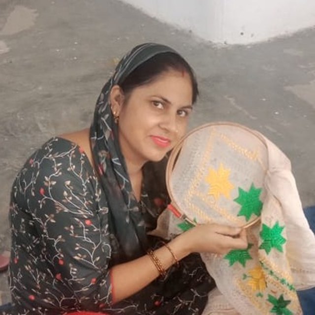 Neha, an artisan with the PESHAS cluster, at her embroidery